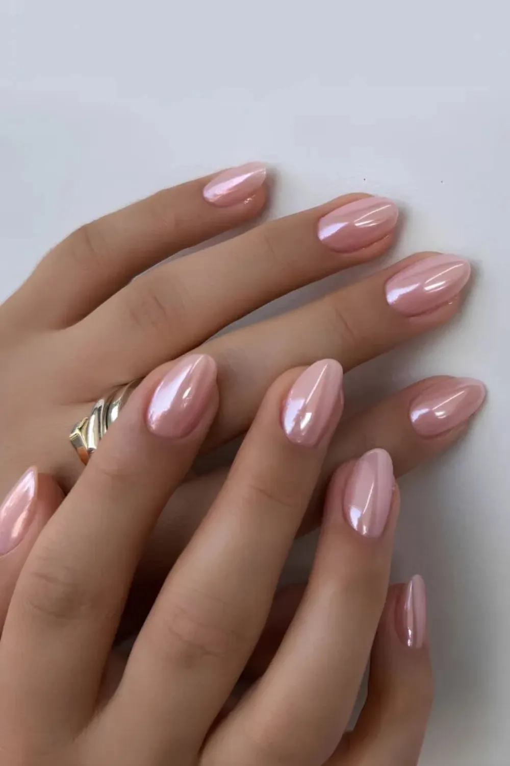 Strawberry Pink Chrome Nails – Glossy pink nails with reflective chrome finish.