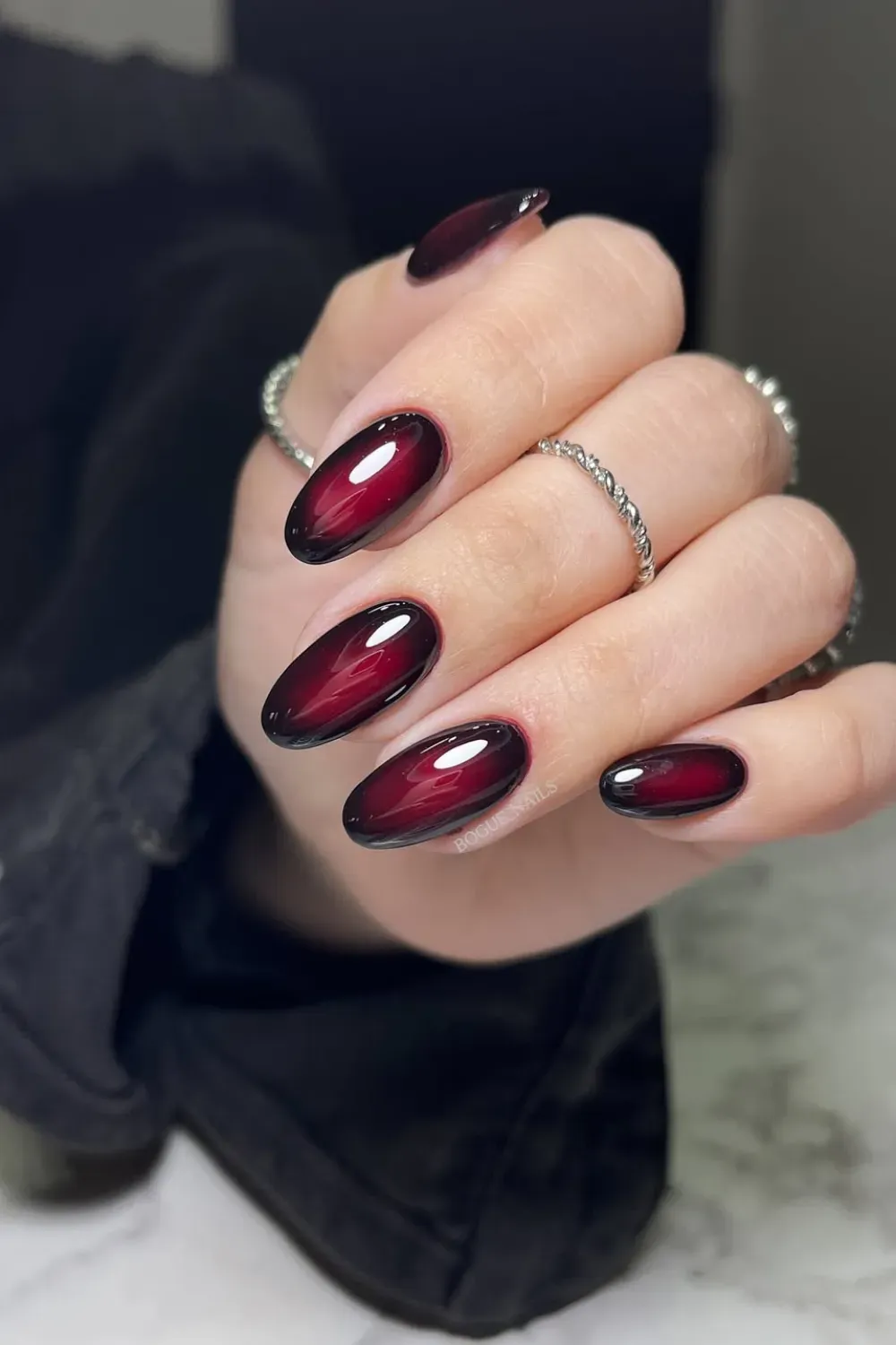 Deep burgundy transitioning into black, creating a bold ombre effect