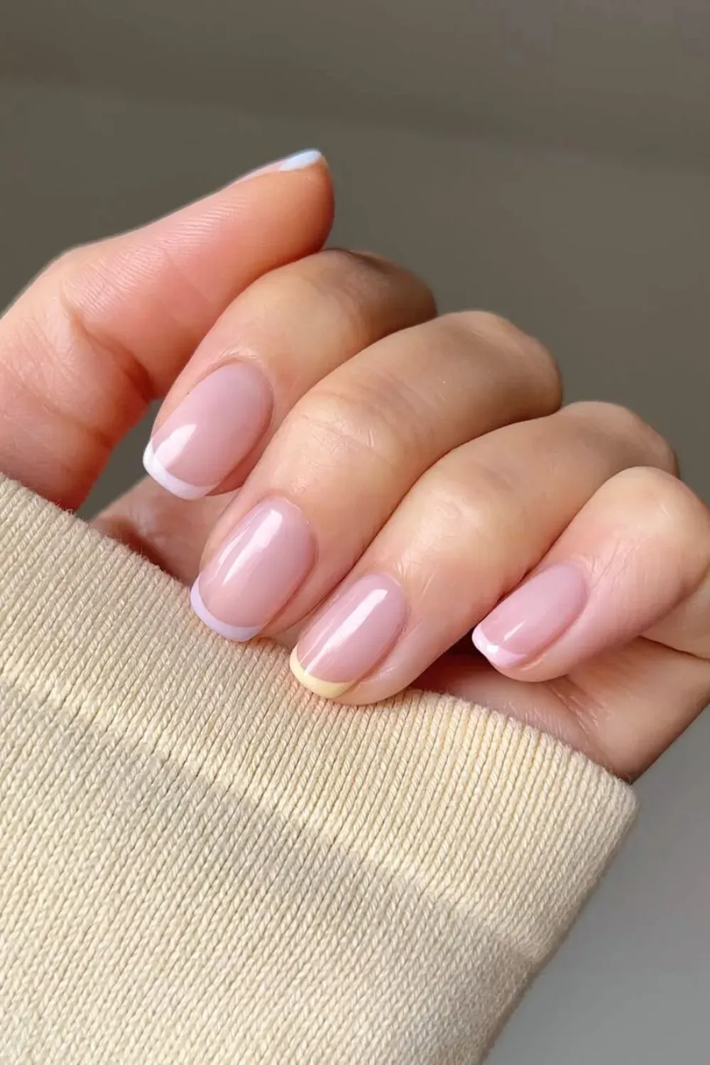 Classic French tips with a modern twist in pastel yellow for a fun, fresh look