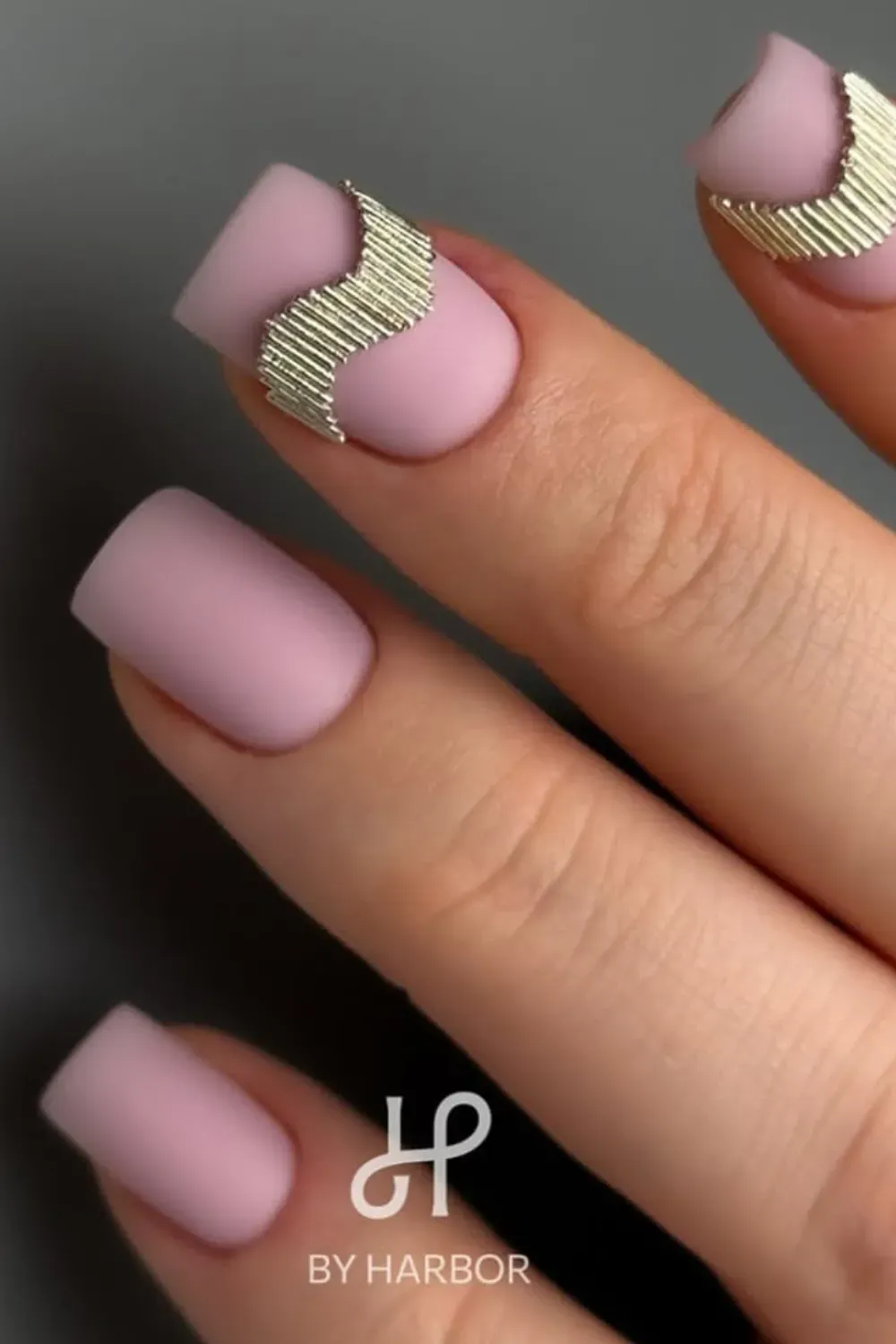 Matte pink short nails with silver accent details.