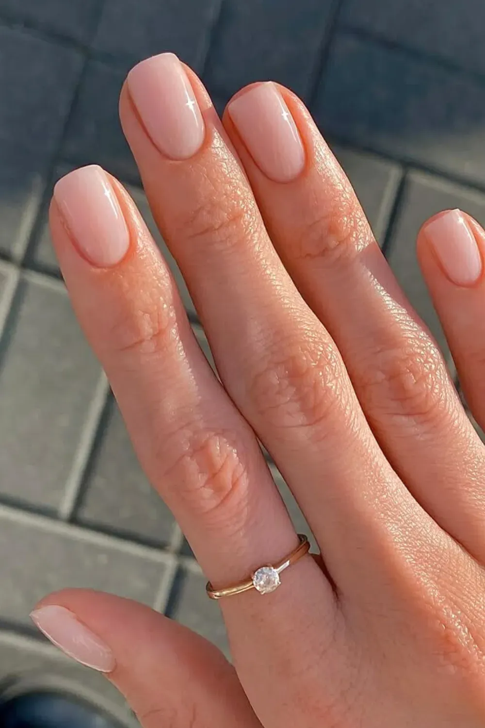 Elegant milky nude short nails with subtle sparkle.