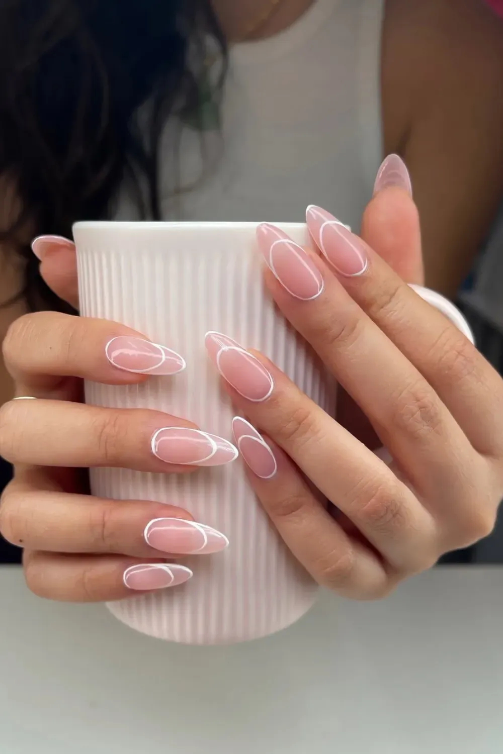  Geometric minimalist nail design with sharp white lines on a neutral base.