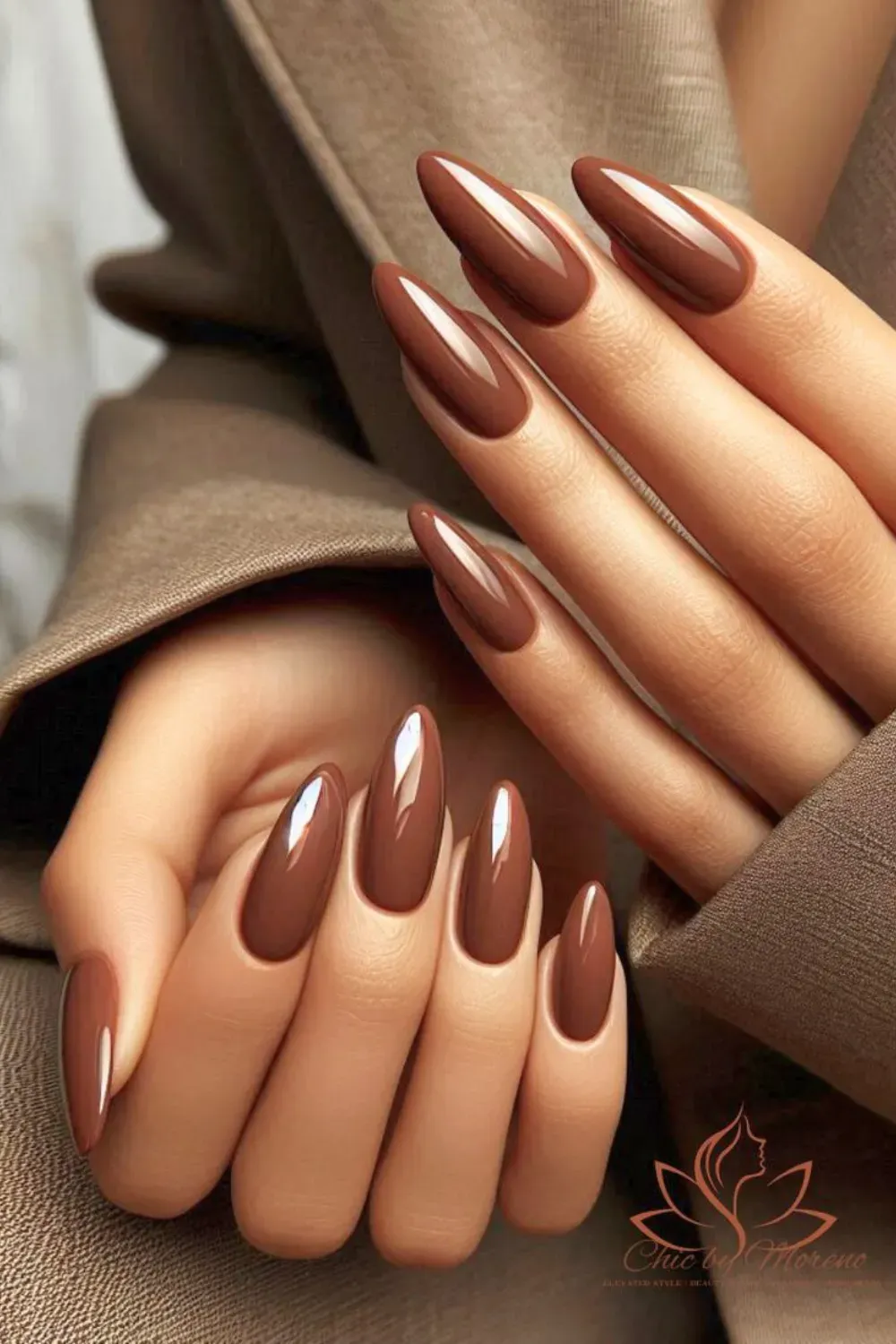 Rich brown almond-shaped nails paired with silver rings, creating a bold yet elegant look.