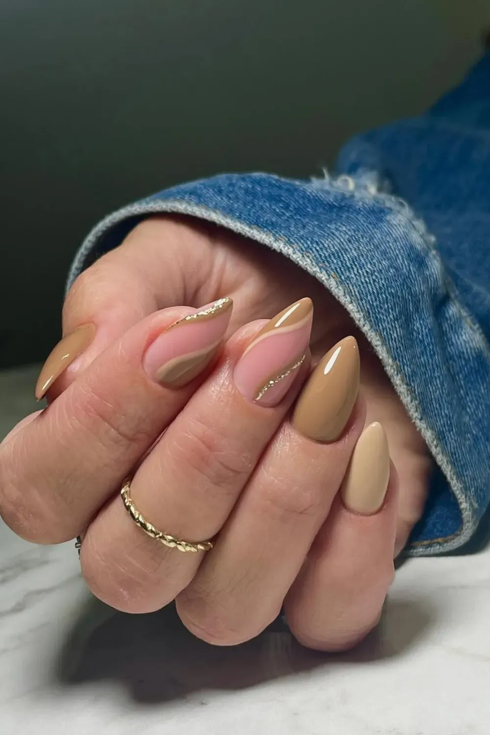Nude nails with delicate gold lines, creating an elegant and minimalist look