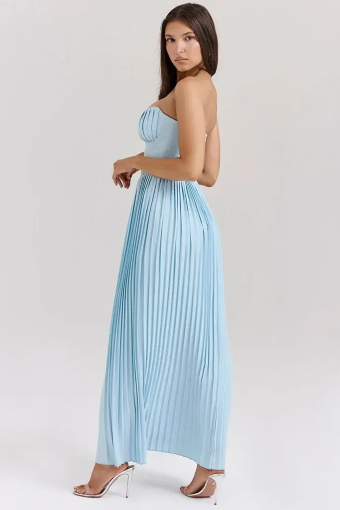 Powder Blue Pleated Strapless Gown - Woman in a strapless pleated gown in light blue, standing against a neutral background.