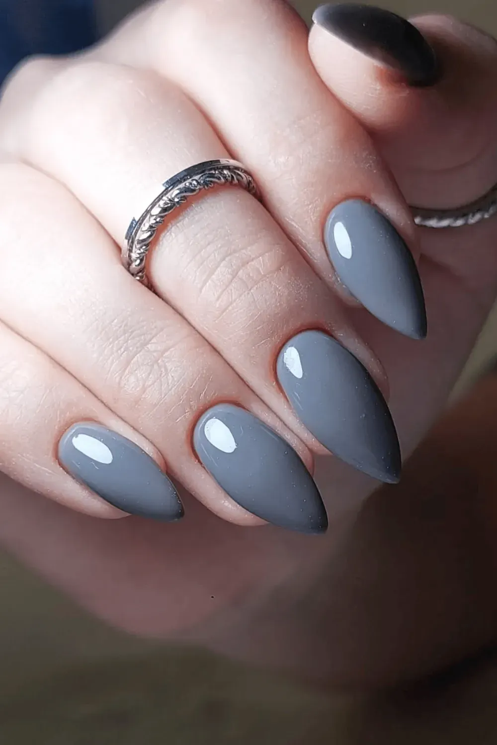 Elegant gray stiletto nails with a smooth, high-gloss finish for a sophisticated and modern manicure