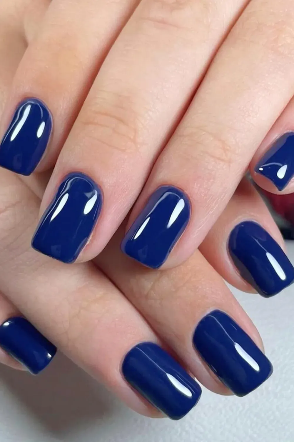 Navy blue nails with a glossy finish and square shape, perfect for a sophisticated and bold style.
