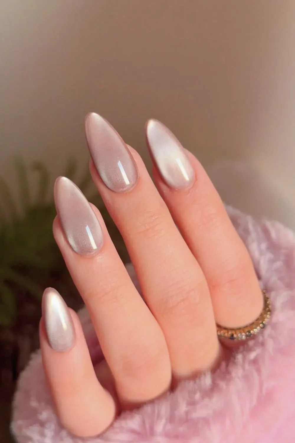 Ombre nails transitioning from pale pink to metallic shimmer, offering a subtle yet stunning gradient effect
