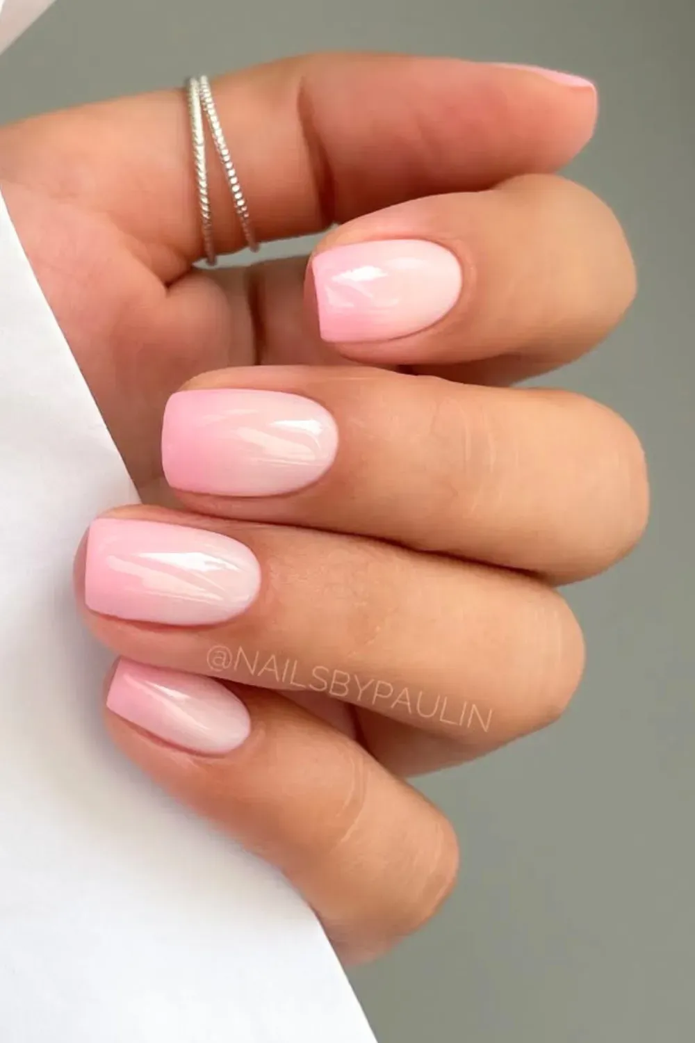 Elegant soft ombre pink nails with a translucent finish.