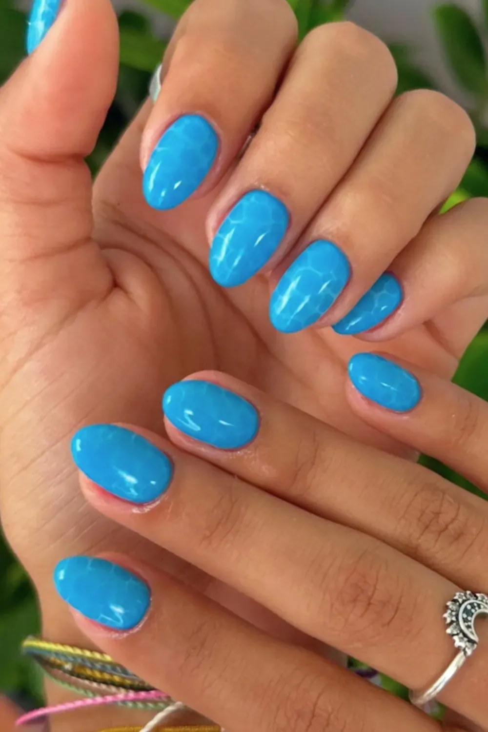 Glossy blue short nails with a poolside vibe, perfect for summer.