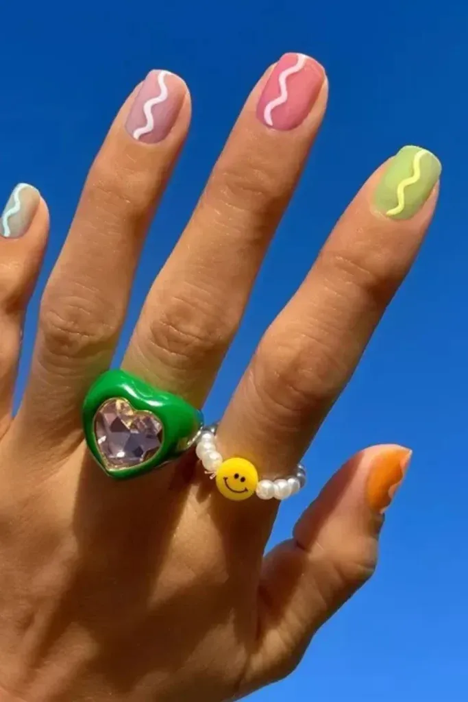 Rainbow Wavy Pastel Nails - Short colorful nails with pastel abstract wave lines in pink, blue, and green