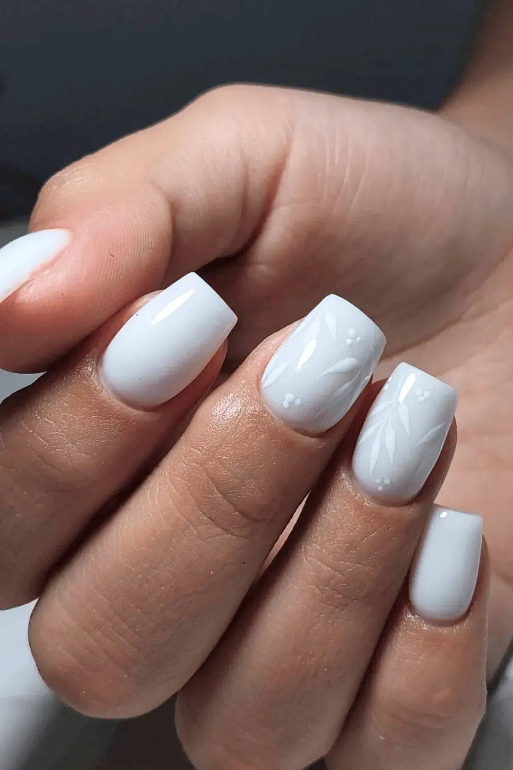 Elegant white square nails featuring delicate marble detailing and floral accents for a refined look