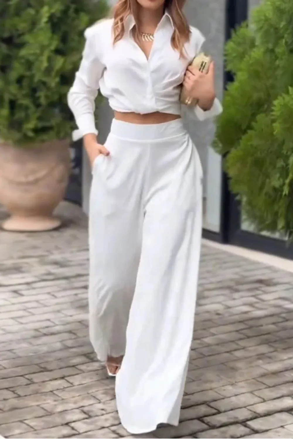 All-White Two-Piece Set 2025 - Woman in a stylish white two-piece outfit with wide-leg pants and crop top