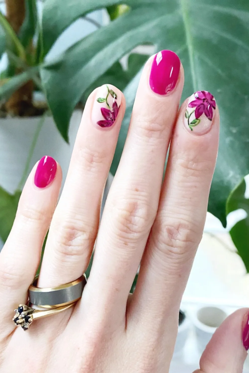 Bold Botanical Bloom Nails – Vibrant flower patterns on a neutral background.