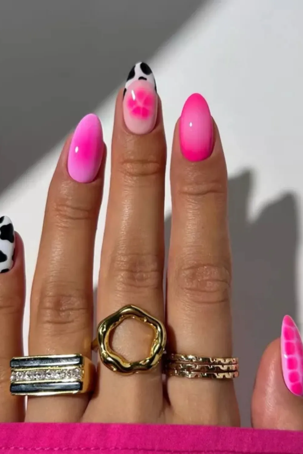 Bold Pink and Cow Print Spring Nail Design - Vibrant pink ombre nails combined with cow print accents for spring