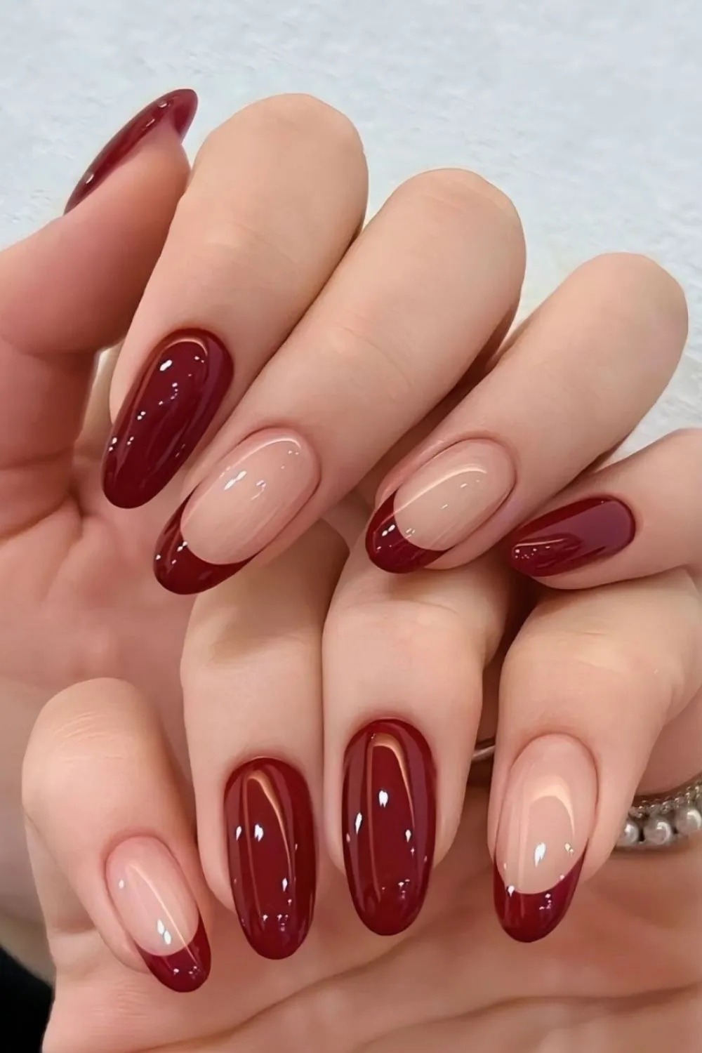 Burgundy French Manicure - Almond-shaped nails featuring burgundy French tips and full burgundy accent nails.