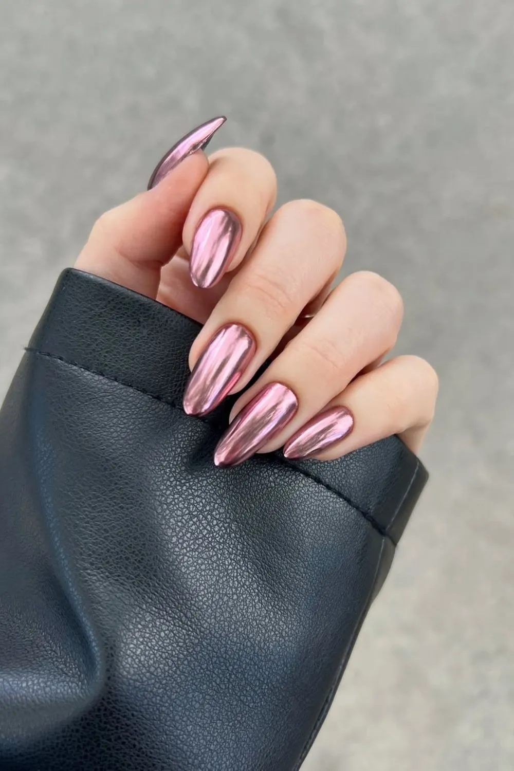 Rose Chrome Almond Nails -** Hand with reflective rose chrome nails in almond shape**