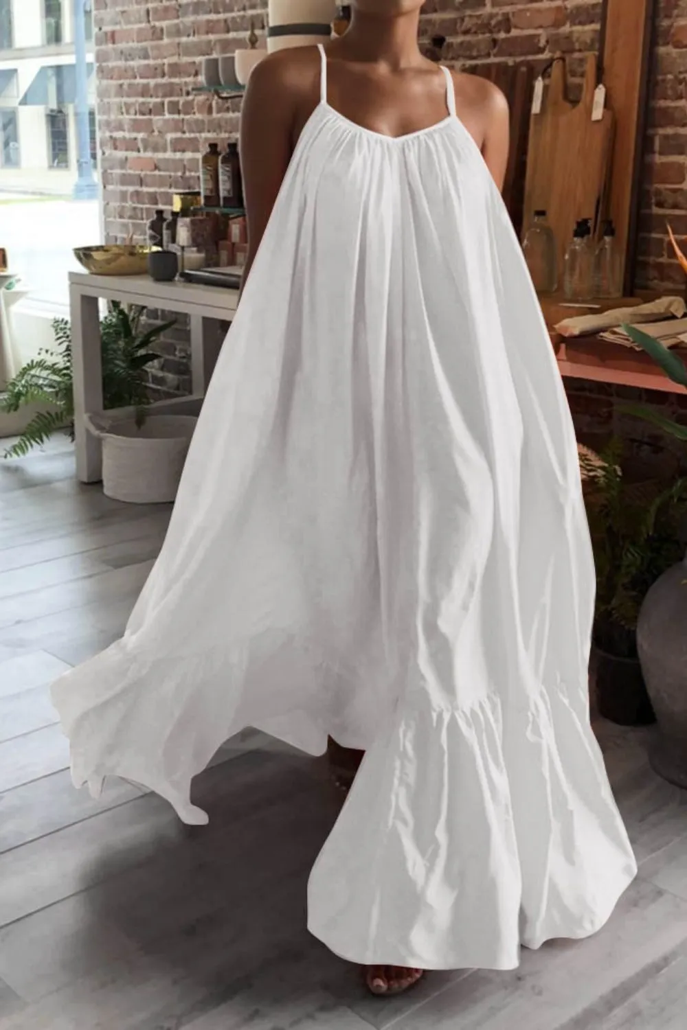 Airy White Maxi Dress for Urban Summer Looks - Woman wearing a loose, white flowing maxi dress indoors