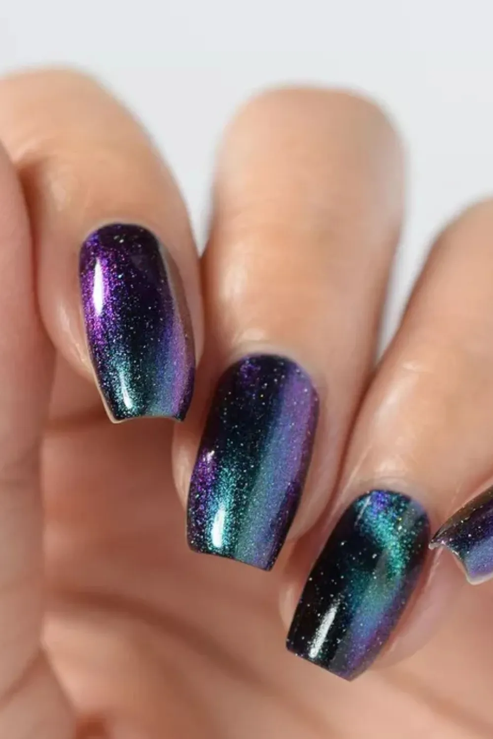 Galaxy Blue Cat Eye Nails- Dark blue cat eye nails with a galaxy-like magnetic shimmer for a mesmerizing spring look.