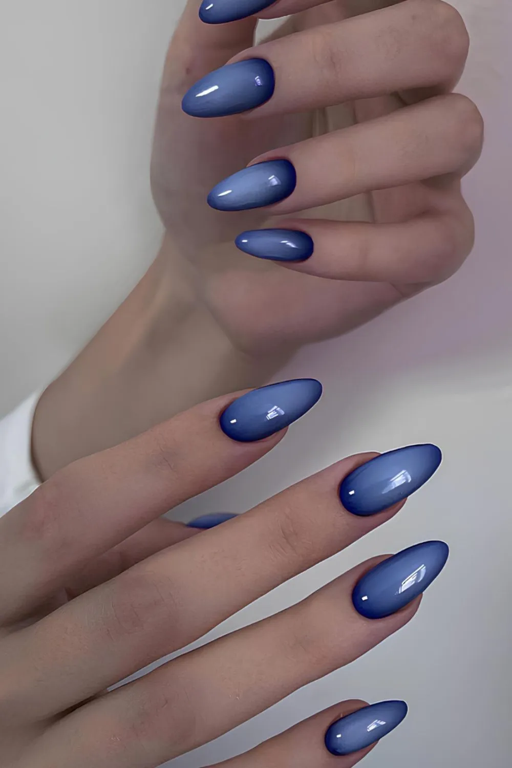 Sapphire Ombré Nails - Glossy ombré nails in shades of deep blue and periwinkle.