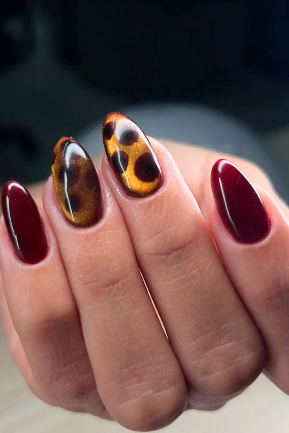 Wine Red and Tortoiseshell Nail Combo - Oval nails painted in glossy wine and tortoiseshell patterns