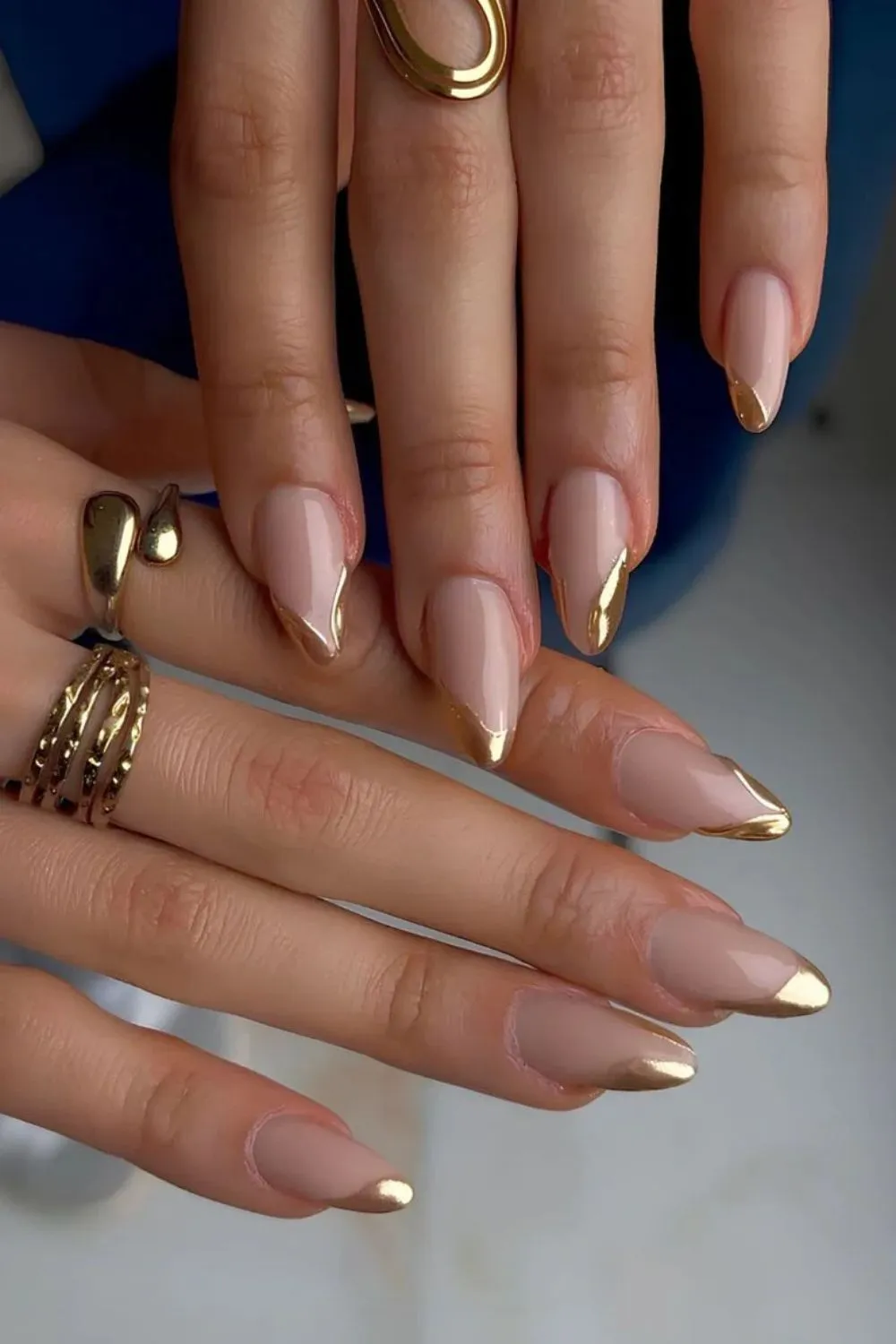 Golden Chrome French Nails - Almond-shaped nude nails with gold chrome French tips.