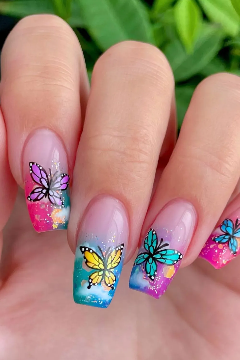 Gradient Butterfly Garden Nails - Gradient nails in pink and purple with butterfly silhouettes.