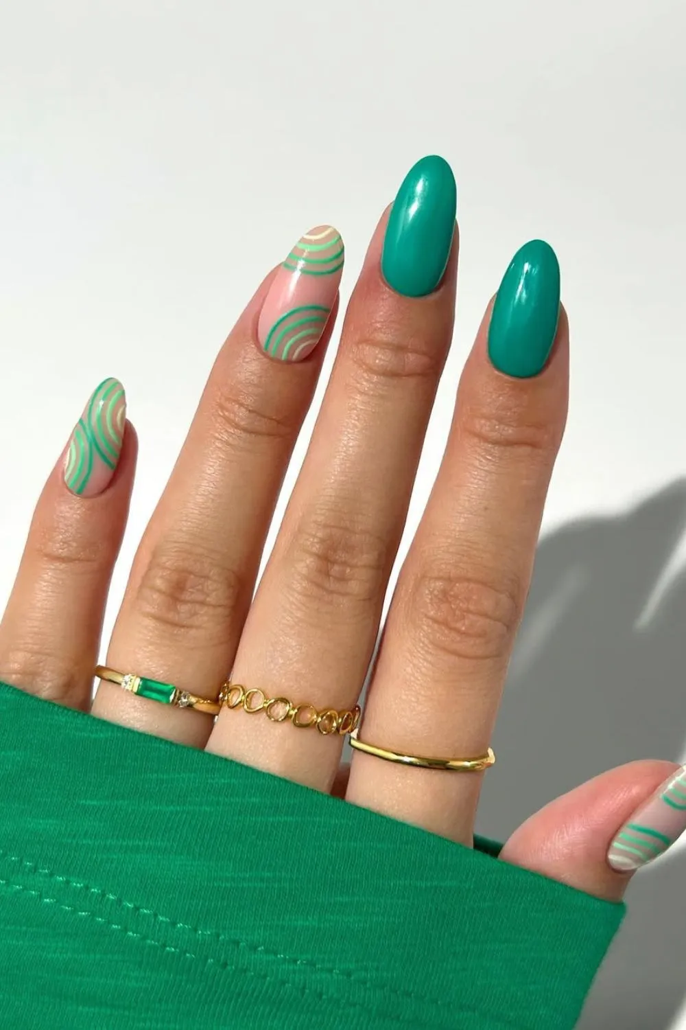 Green Swirl and Solid Nail Design -** Hand with green swirls on nude base mixed with solid green nails**