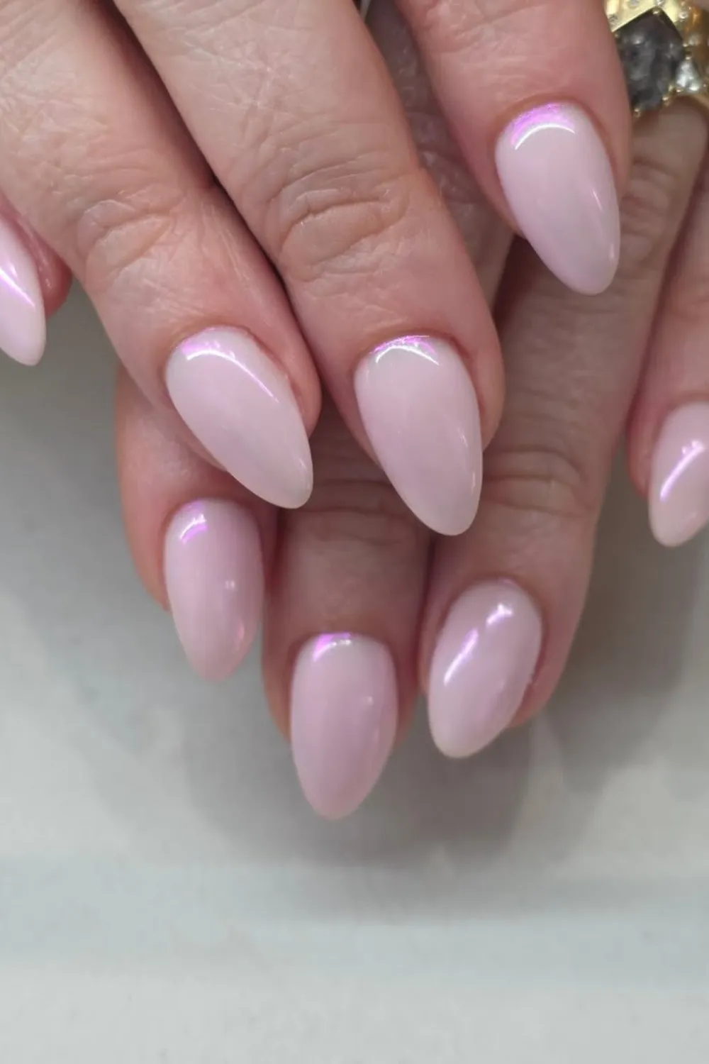 Jelly Pink Chrome Nails- Translucent pink chrome nails reflecting light with a glossy finish.