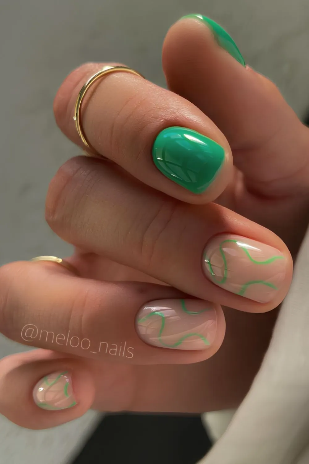Leafy Green Swirl Short Nails - Short round nails with nude base and light green swirl art, plus solid green accent nail.
