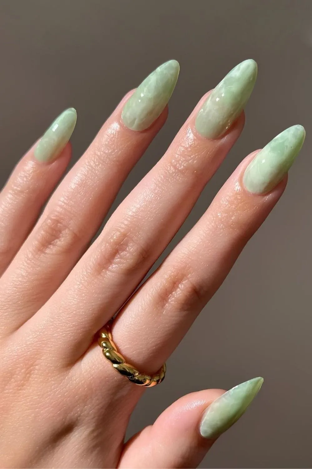 Matcha Green Marble Nails - Almond-shaped nails with marble design in soft jade and matcha green tones.