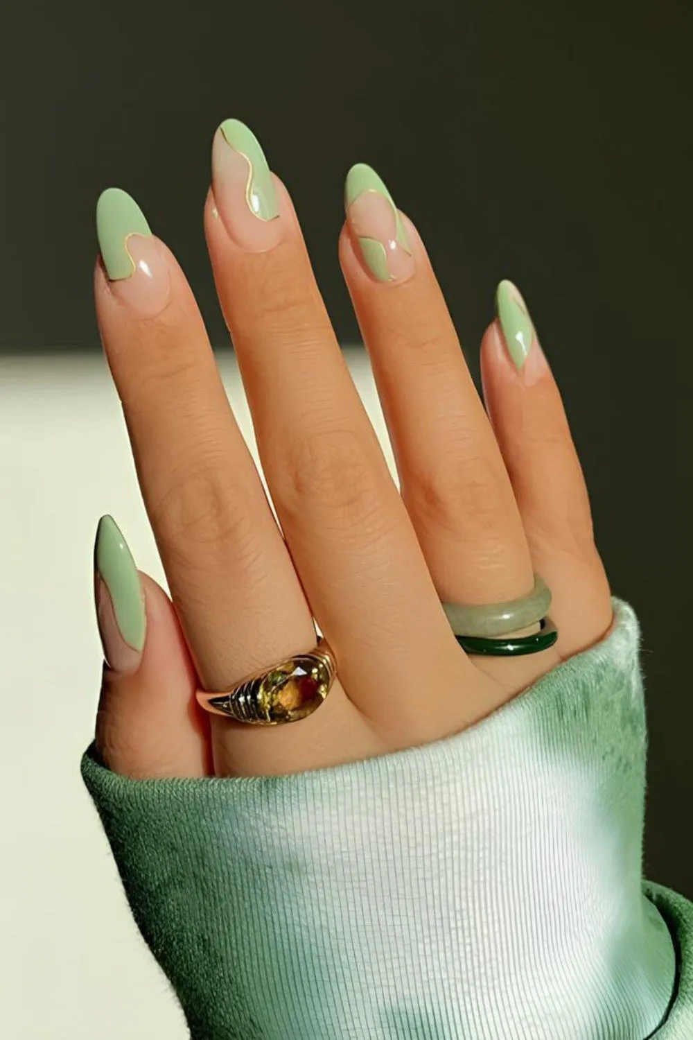Mint Green Swirl Nails - Almond nails with mint green swirls on a nude base.