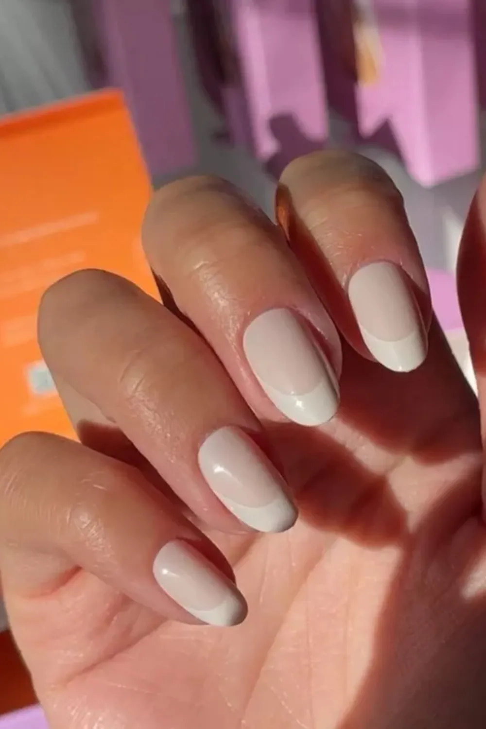 Modern Soft White Spring Nails 2025 - Elegant soft white medium-length spring nails with a glossy finish