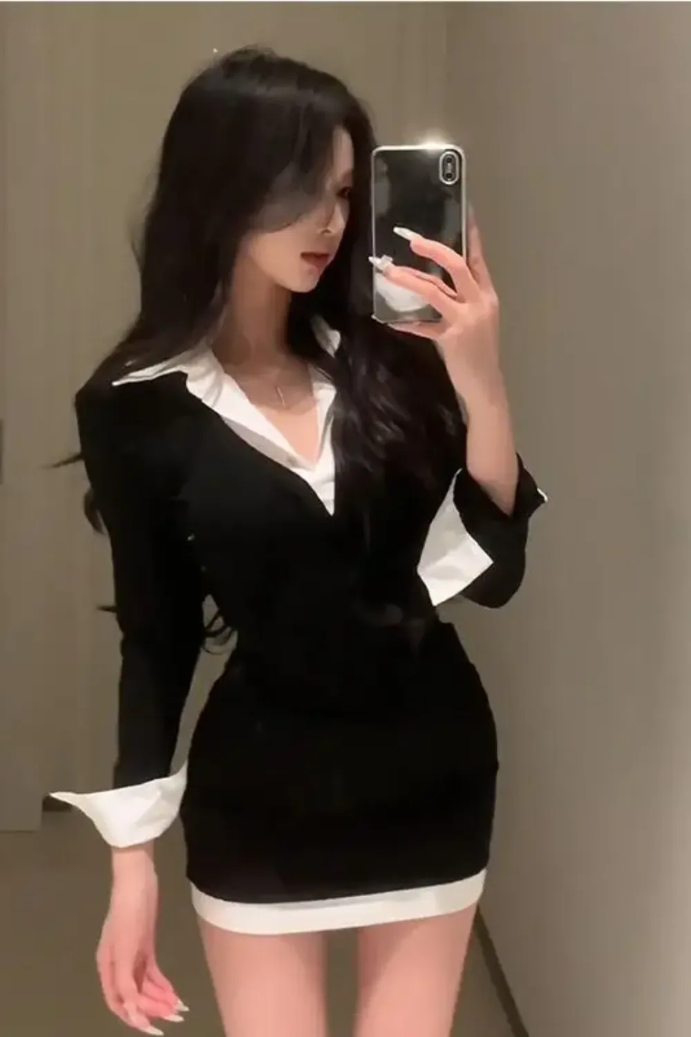 Monochrome Contrast Dress 2025 - Woman in a fitted black and white mini dress