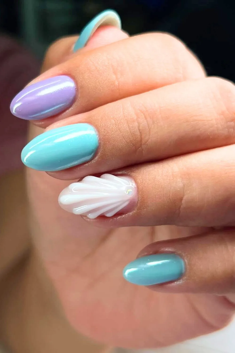Sea-Inspired Pastel Nail Design - Aqua and lavender nails with a white 3D seashell accent