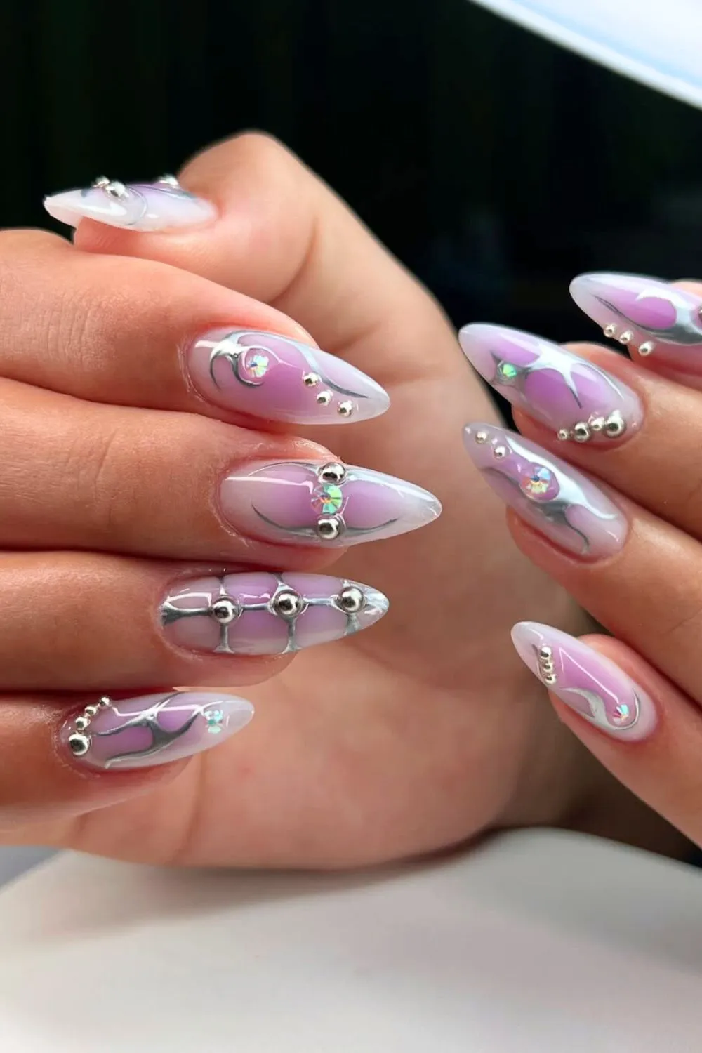 Lavender and Silver Galaxy Nail Art - Almond nails with silver chrome beads and holographic accents on a purple base