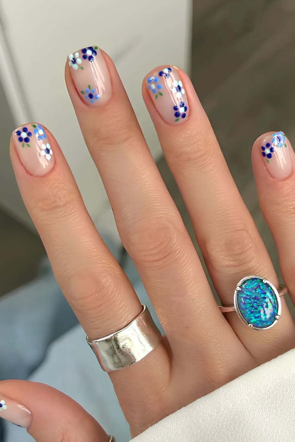 "Tiny Blue Floral Nail Art on Clear Base - Delicate Spring-Inspired Nails"