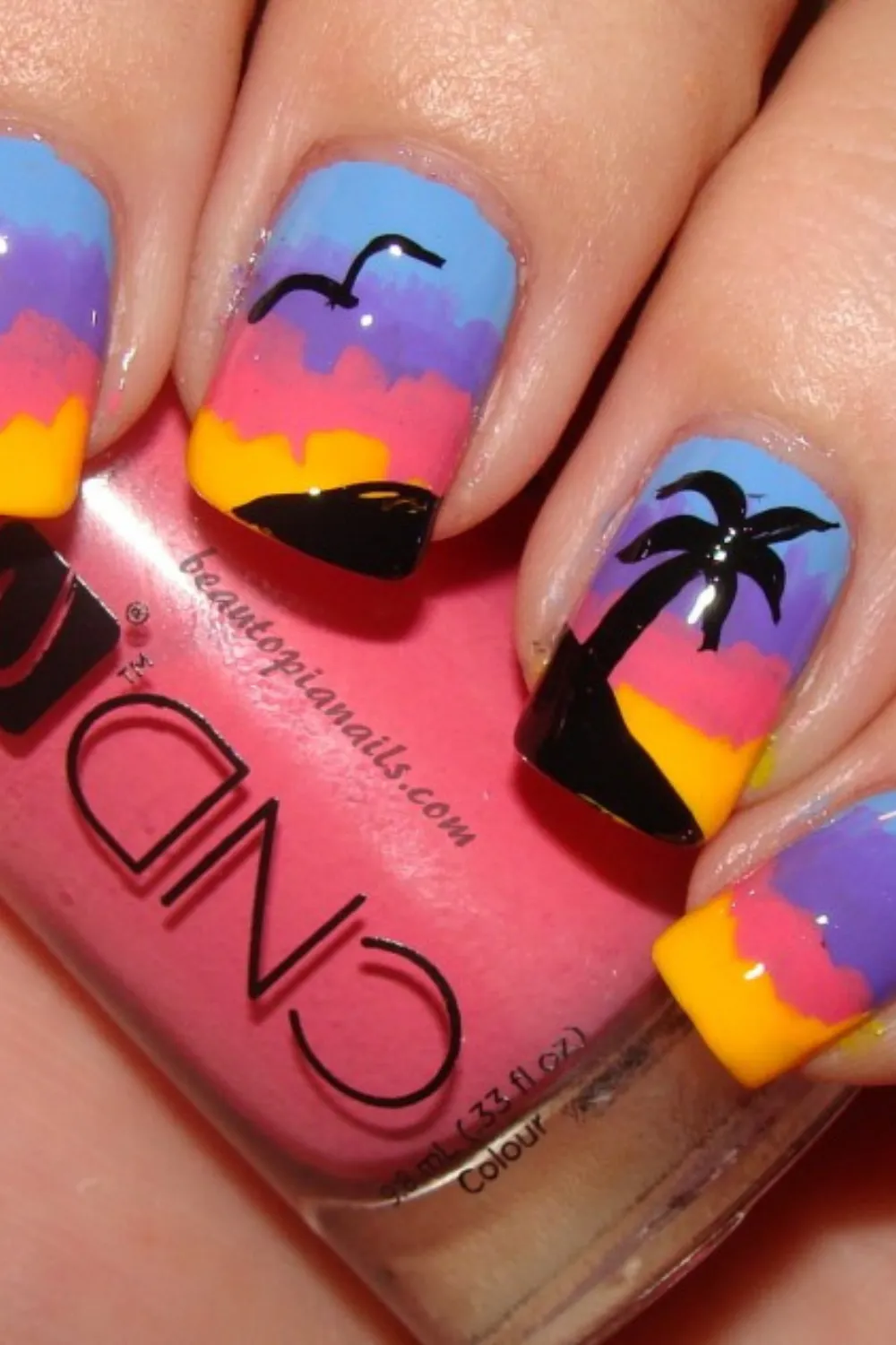 Vibrant Floral Sunset Nail Art - Bright pink and red floral designs over a warm sunset gradient base.