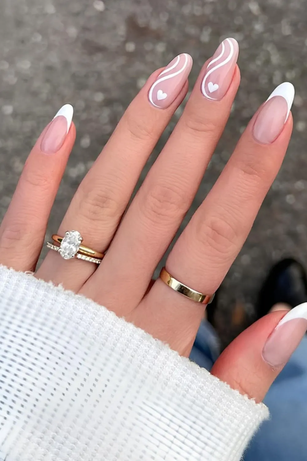 White Heart Swirl Nails - Almond-shaped nails with white swirl lines and heart details.