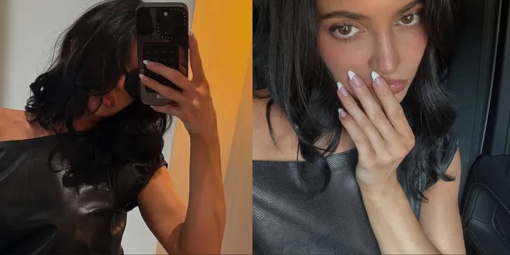 Kylie Jenner’s chic Deep 90’s French manicure, featuring clean white tips, worn with a minimalistic black outfit and soft makeup