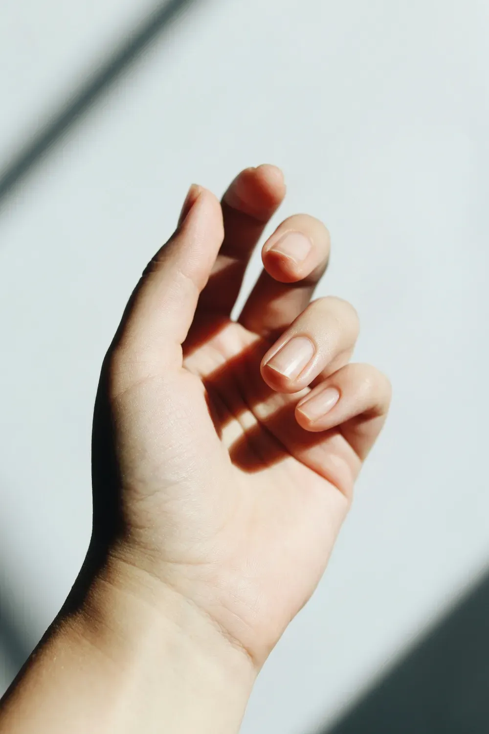 A close-up of a hand with natural nails