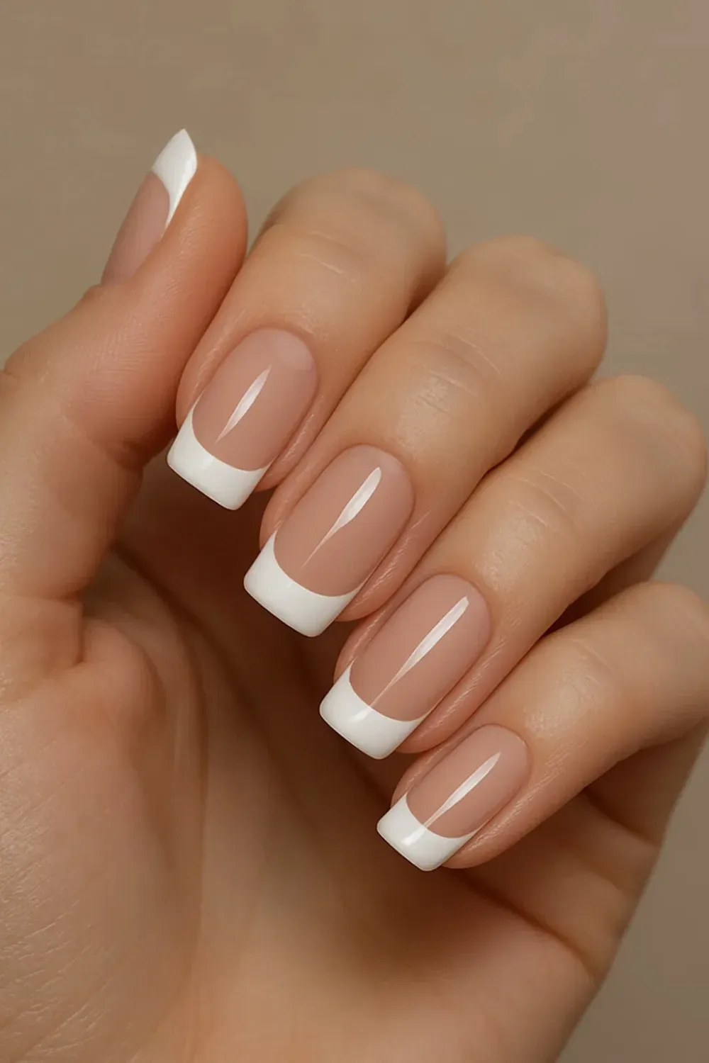 Classic French manicure with bold white tips on natural nails, showcasing the timeless elegance of the Deep 90's French loo