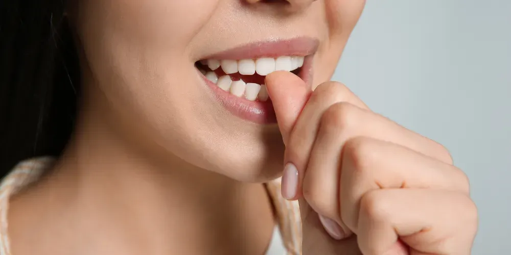Image of a person biting nails