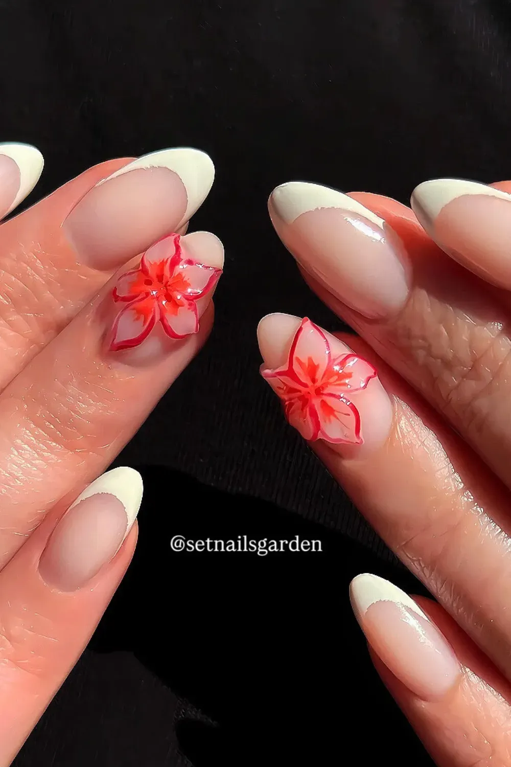 White French Tips with Red Floral Twist Alt Text: White French tips adorned with delicate red floral accents for a chic and sophisticated look