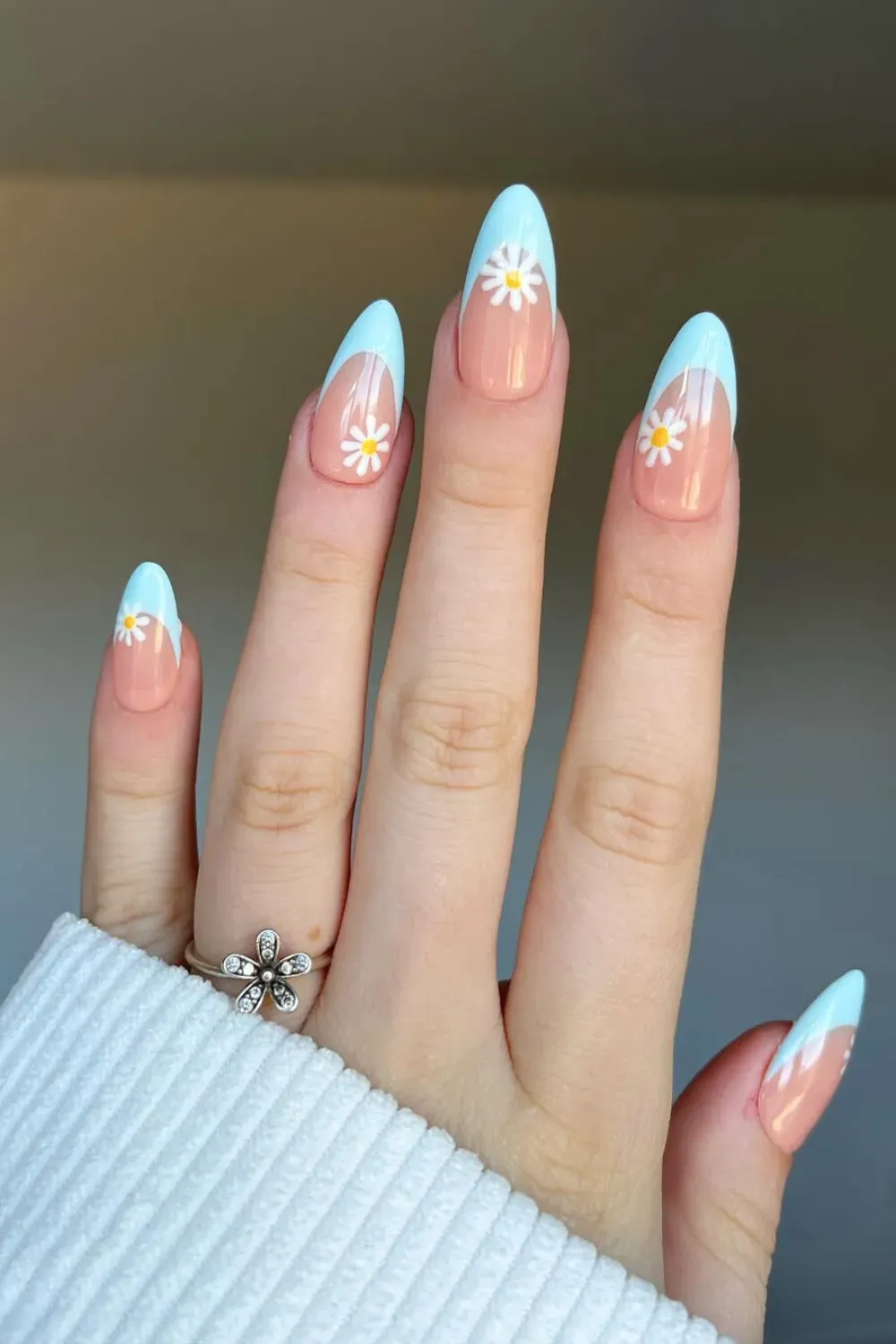 Blue French Tips with Daisies Alt Text: Light blue French tip nails with delicate white daisies for a soft, summery look