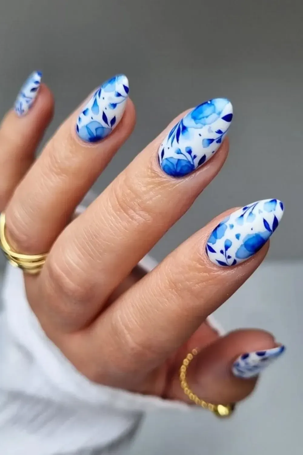 Blue Marbled Nails with Floral Detailing - Artistic blue marbled nails with subtle floral detailing