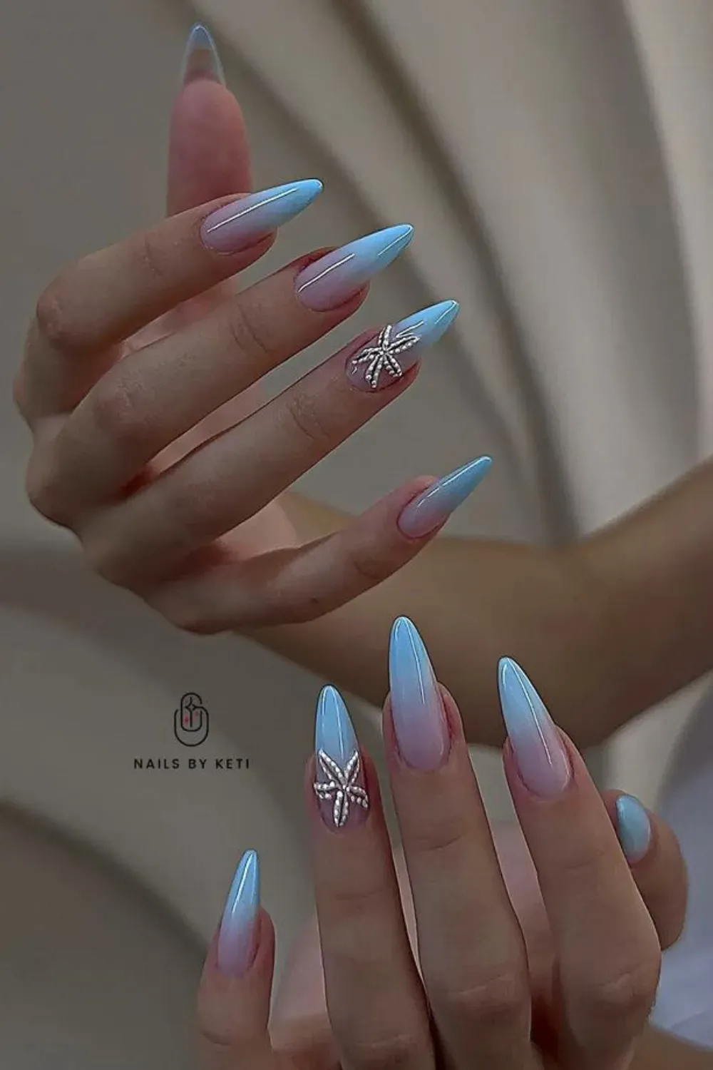 Blue Ombre Floral Nails - Elegant blue and pink ombre nails with a soft floral accent on the ring finger