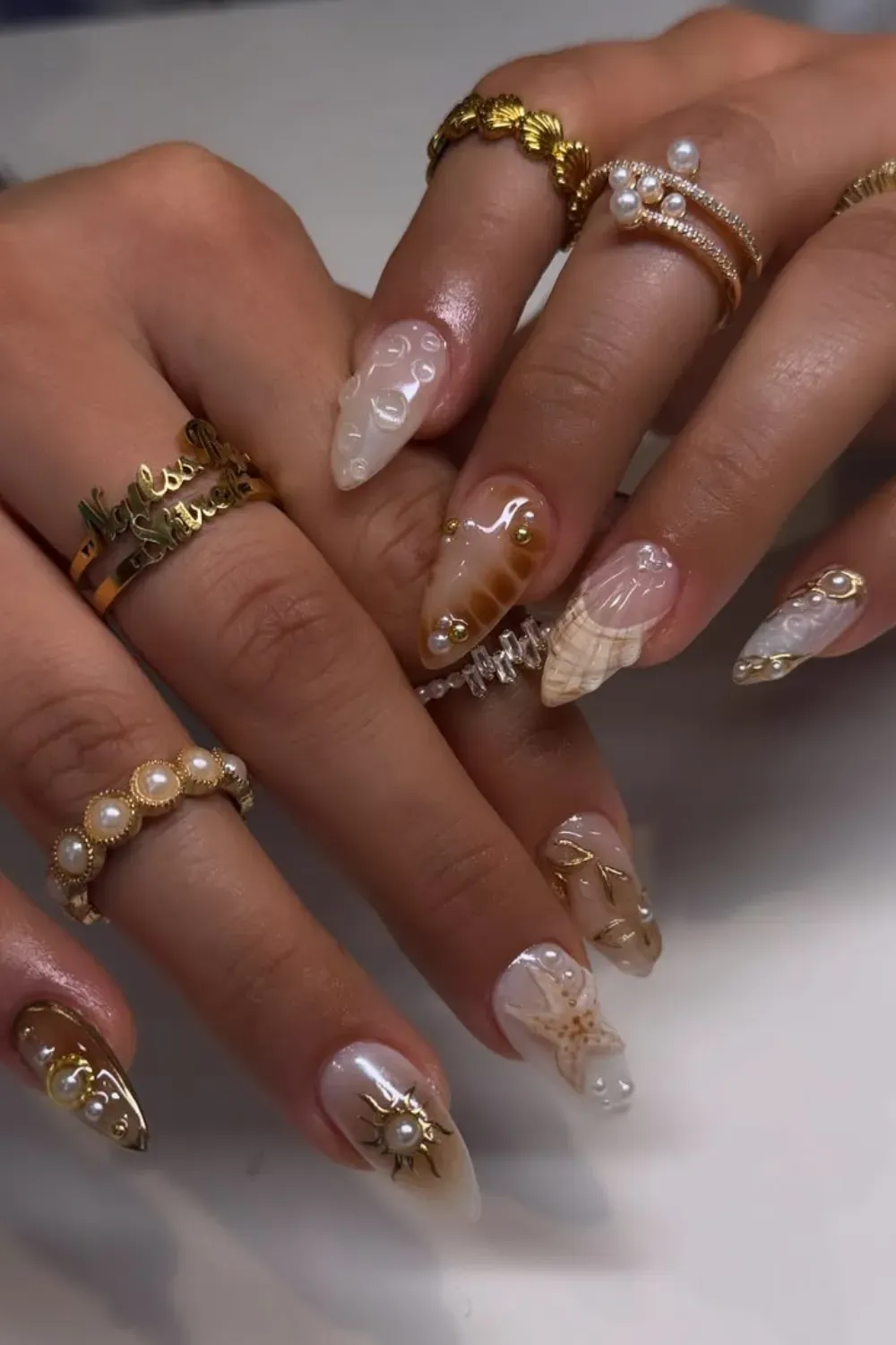 Gorgeous pink and yellow ombre nails with a delicate starfish design for a fresh, beach-inspired style