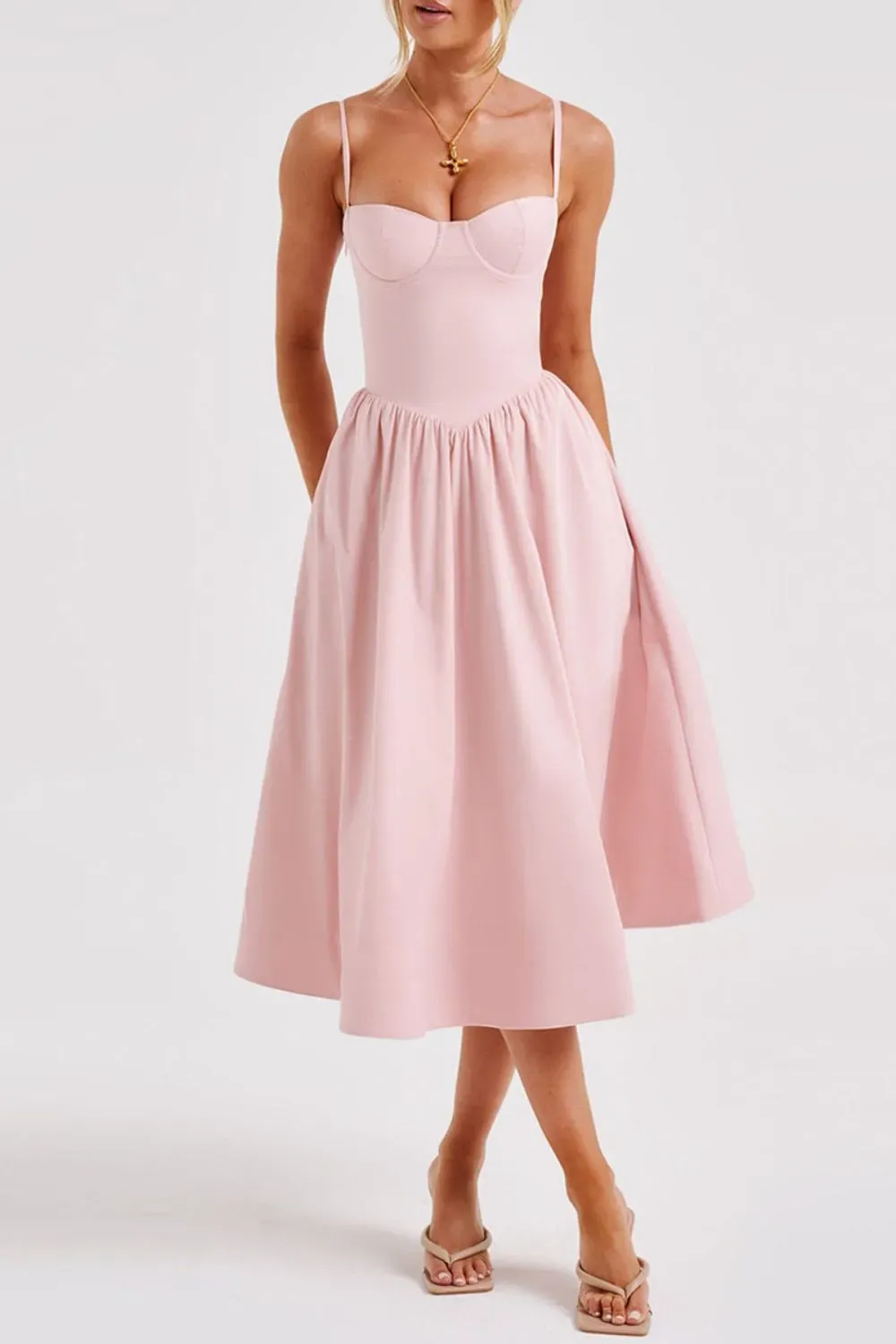 Blush Pink Midi Dress with Spaghetti Straps - Woman in a light pink midi dress with fitted bodice and flared skirt