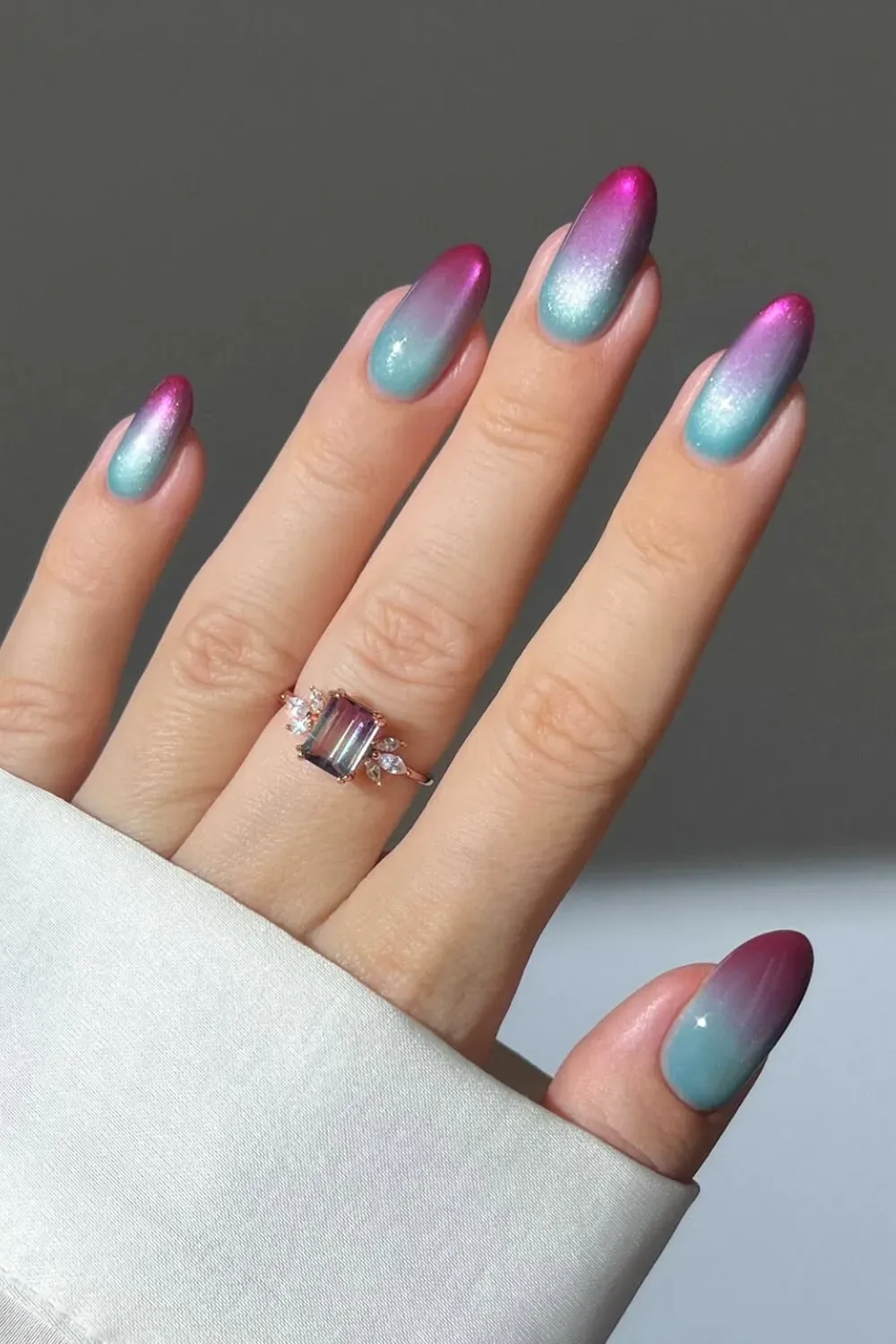 Electric neon pink and blue ombre nails with a bold statement